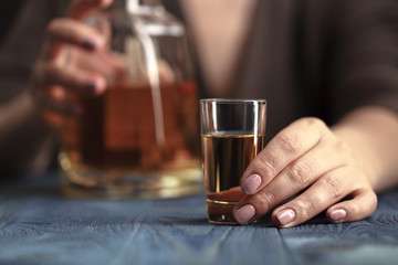 Drunk woman holding an alcoholic drink, Focused on the drink