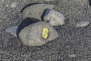 olivine gemstone also called peridot at volcanic beach