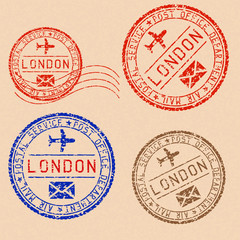 Collection of LONDON postal stamps partially faded on beige paper background