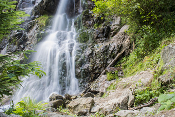 Waterfall on mountain river in Carpathian Mountains , Romania