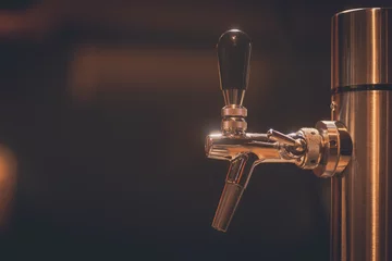 Tuinposter Beer tap in a bar or restaurant © bizoo_n