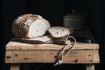 Bread slices on rustic table and dark background