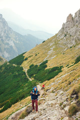 Hikers making their way up a rugged mountain trail