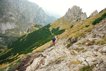 Fototapeta na wymiar Hikers walking along a trail in rugged mountain terrain