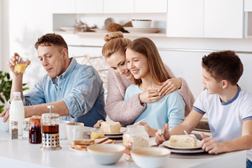 Obraz na płótnie Canvas Pleasant family having breakfast in the kitchen