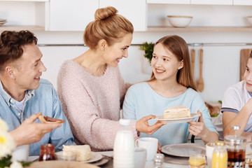 Obraz na płótnie Canvas Positive family having breakfast in the kitchen