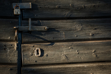 Old lock on barn door in afternoon light
