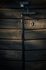 Old lock on barn door in afternoon light