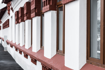 Brick wall of old building with row of window