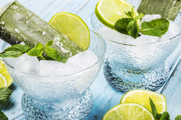 Popsicles on a stick of lime on a wooden table