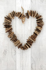 Rustic Driftwood Heart. On distressed white wood background.