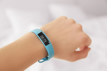 Female hand with sleep tracker on blurred background