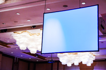Front view of lecture room with empty white projector screen