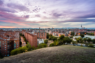 Fototapeta na wymiar Madrid cityscape at sunset with purple clouds