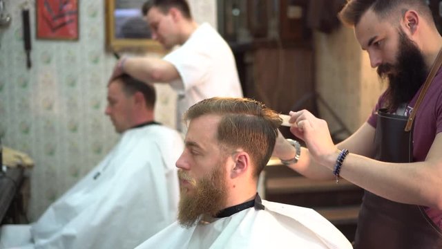 Men cut their hair in the barbershop