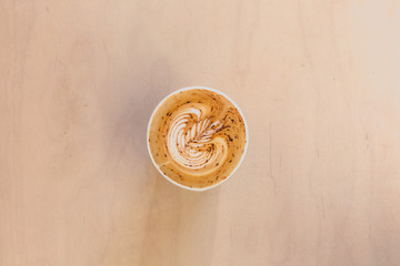 Latte with Latte art in coffee shop on wooden table