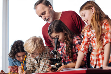 Admirable professional teacher assisting his students