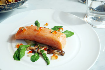 Slow Cooked Salmon fillet steak with salad and roe salmon on white plate, Sous-Vide Cooking Salmon Fish.