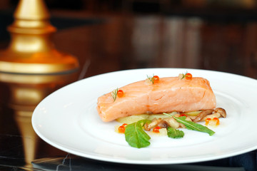 Slow Cooked Salmon fillet steak with salad and roe salmon on white plate, Sous-Vide Cooking Salmon Fish.