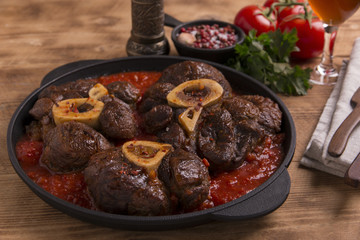 roasted meat on the bone Osso Buco in tomato sauce