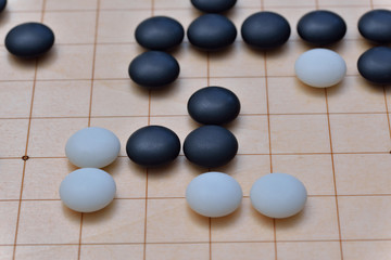 GO game. GO is an abstract strategy board game for two players, in which the aim is to surround more territory than the opponent.