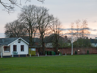Sunset Over the Green and House of a Cricket Club