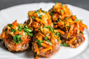 Delicious chicken or turkey meatballs with rice, vegetable in tomato sauce. white plate. selective focus
