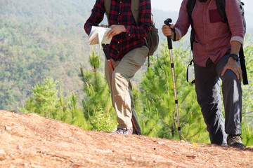 Young couple tourists with map in the park. Adventure.