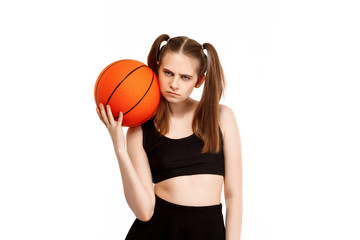 Young pretty girl posing with basketball, isolated on white background.