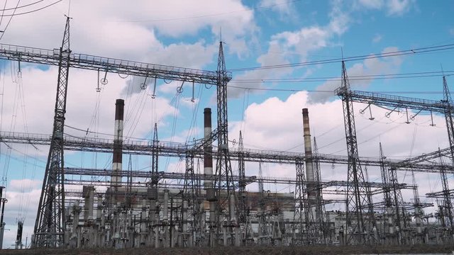 CHP industry. View of the power station, smoke comes from pipes. 4k footage.
