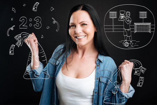 Delighted cheerful woman holding bags with money