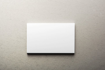 Business card, over gray background. Horizontal shoot.