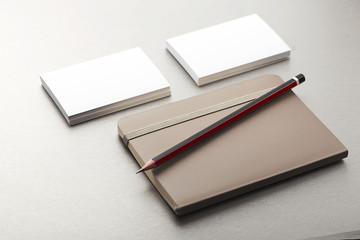 Pencil, business card and notepad on gray background. Business.