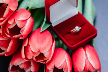 red tulip bouquet and diamond engagement ring