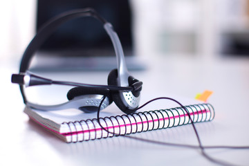 Call center service operator empty working place. Headset, glasses, keyboard and monitor at...