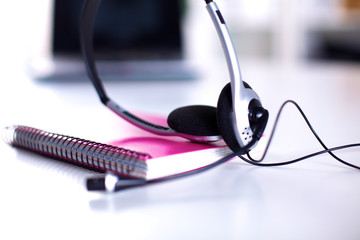 Call center service operator empty working place. Headset, glasses, keyboard and monitor at helpdesk employee workplace. Effective and efficient business information, help and support concept