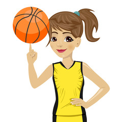 teenager girl spinning basketball ball with her finger