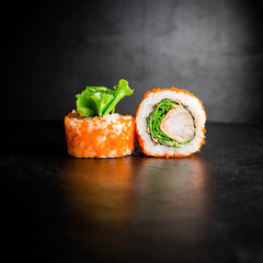 Sushi rolls on a black background. Japanese food