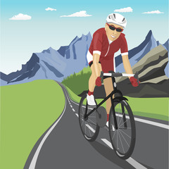 Male professional cyclist riding in mountains