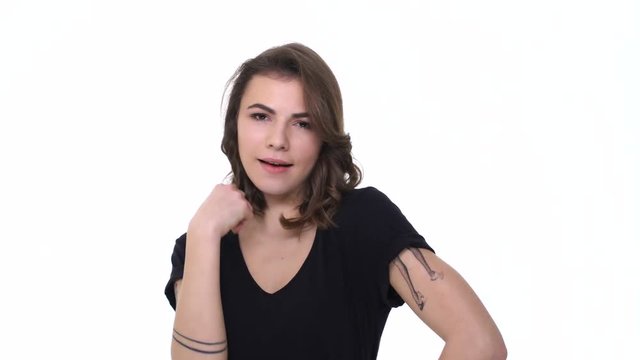 Attractive young woman flirting and doing beckon gesture with finger isolated