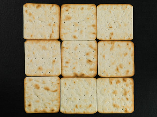 Cream Crackers Against a Black Background