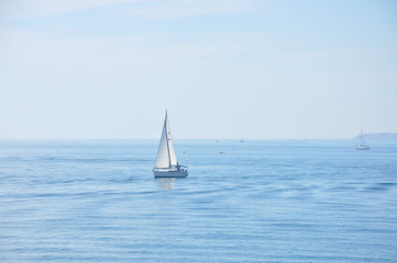 Yachts and boats sailing along the calm water of the Mediterranean Sea during the day