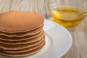 Stack of pancakes with honey for breakfast