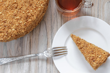 Round cake napoleon on a wooden background. Close up