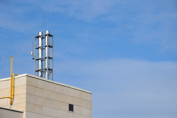 Modern chimney on the roof of hi tech home. Big metal chimney system