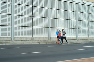 Group of people running jogging fast motion shot