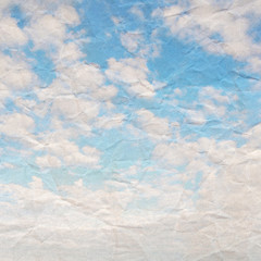 Blue sky on crumpled paper background