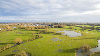 Aerial view of a lake and river area in the countryside late afternoon in the winter