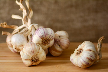 Closeup of whole garlic cloves on a wooden background