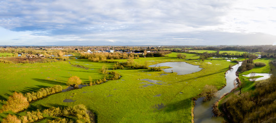 Aerial view of a lake and river area in the countryside late afternoon in the winter